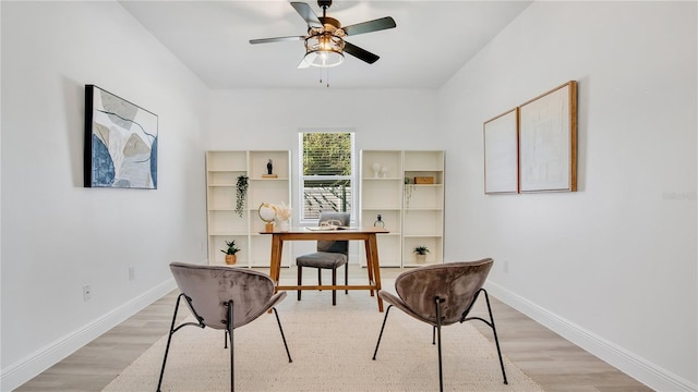 office area with light wood-type flooring and ceiling fan