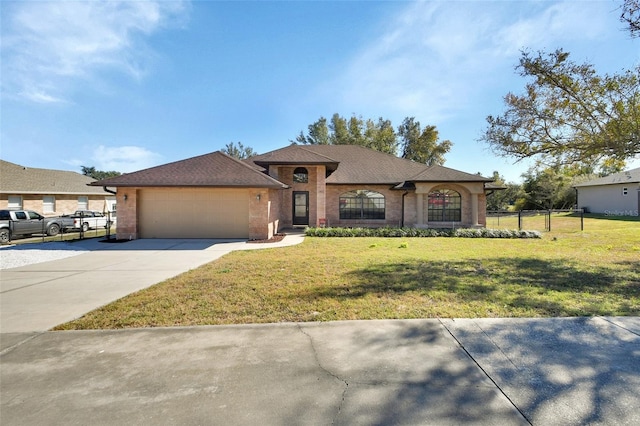 view of front of house with a garage and a front lawn