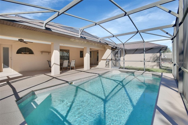 view of swimming pool with a patio, ceiling fan, and a lanai