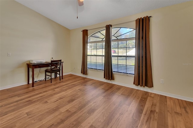 unfurnished room with ceiling fan, a textured ceiling, and hardwood / wood-style flooring