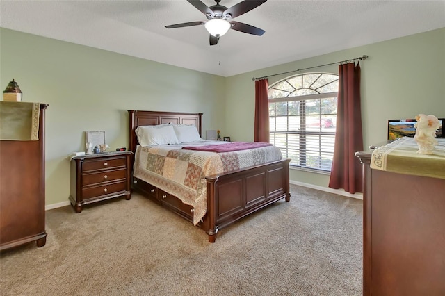 bedroom with ceiling fan and light carpet