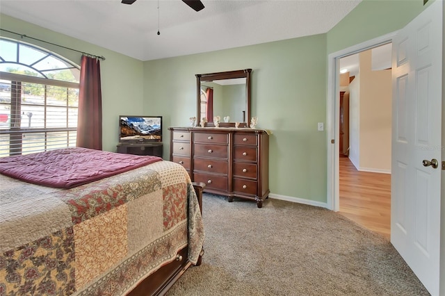 bedroom with ceiling fan and light colored carpet