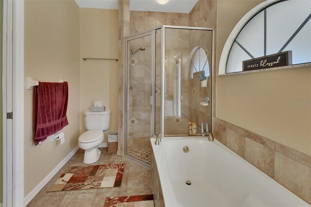 bathroom featuring plus walk in shower, tile patterned floors, and toilet