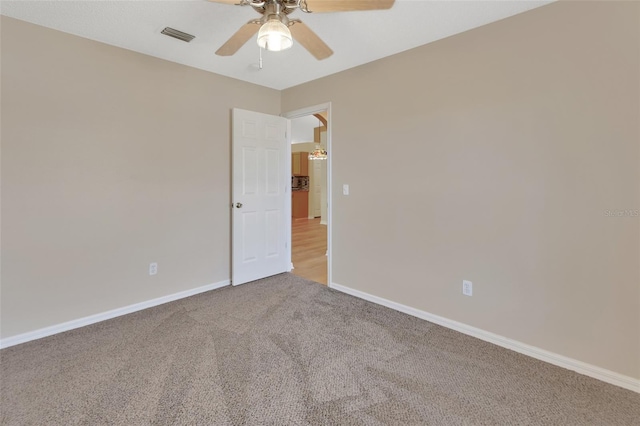 unfurnished room featuring carpet and ceiling fan