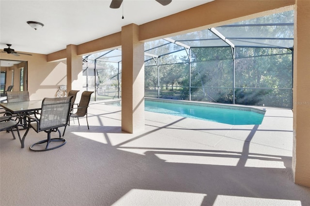 view of swimming pool with ceiling fan, a lanai, and a patio