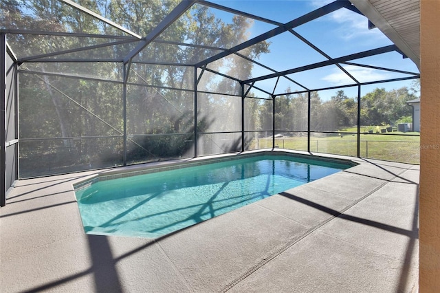 view of pool featuring glass enclosure and a patio area