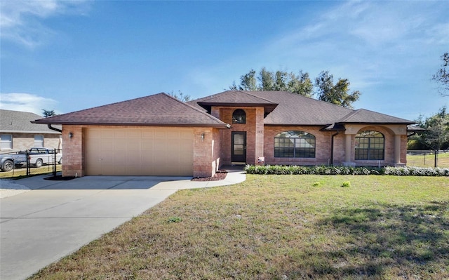 single story home featuring a garage and a front lawn