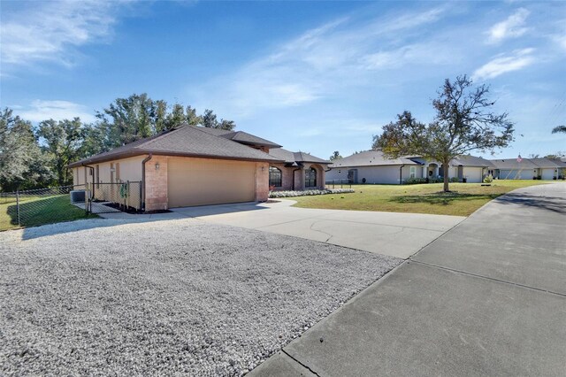 ranch-style home with a front yard and a garage