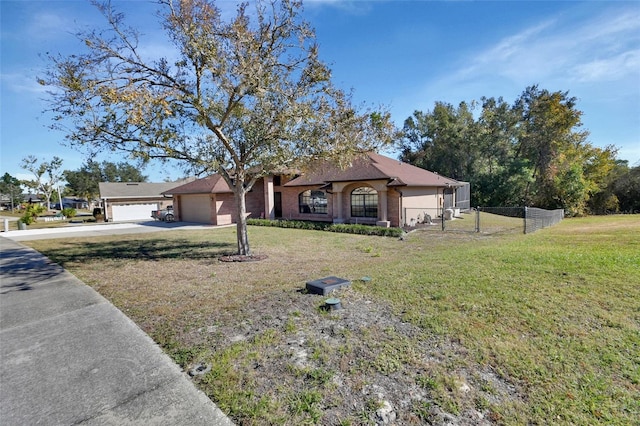 ranch-style house featuring a garage and a front yard