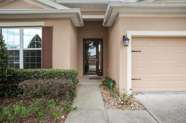 view of exterior entry with a garage