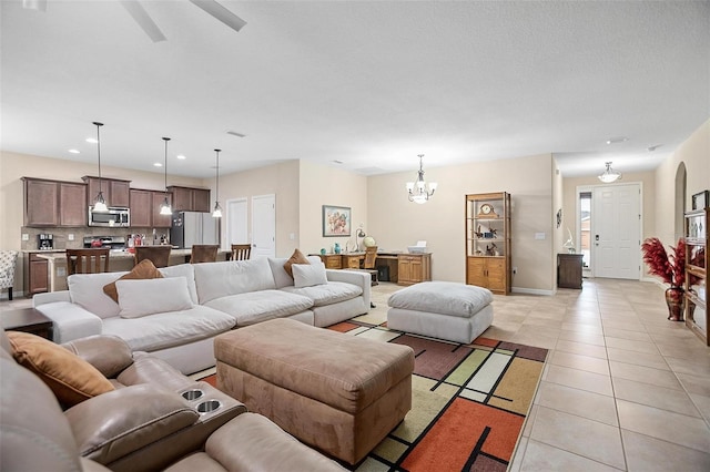 tiled living room featuring a chandelier