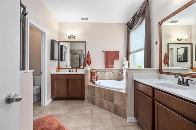 full bathroom featuring tile patterned floors, vanity, toilet, and separate shower and tub