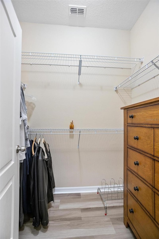 spacious closet featuring light wood-type flooring