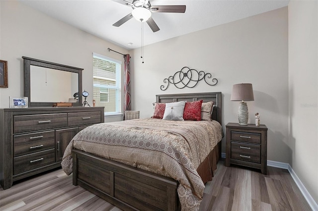 bedroom with ceiling fan and light hardwood / wood-style floors