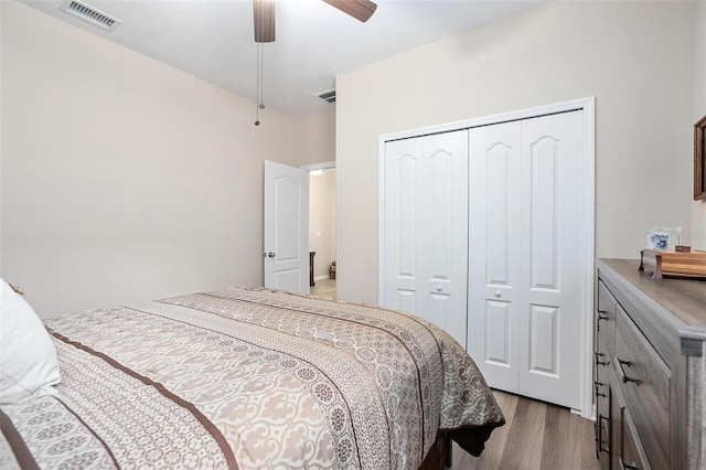 bedroom featuring light wood-type flooring, a closet, and ceiling fan