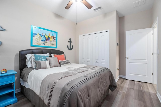 bedroom featuring ceiling fan, a closet, and hardwood / wood-style floors