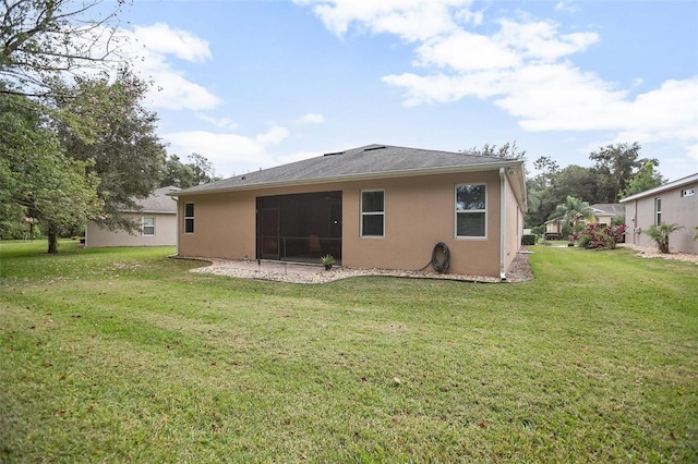 rear view of house featuring a yard