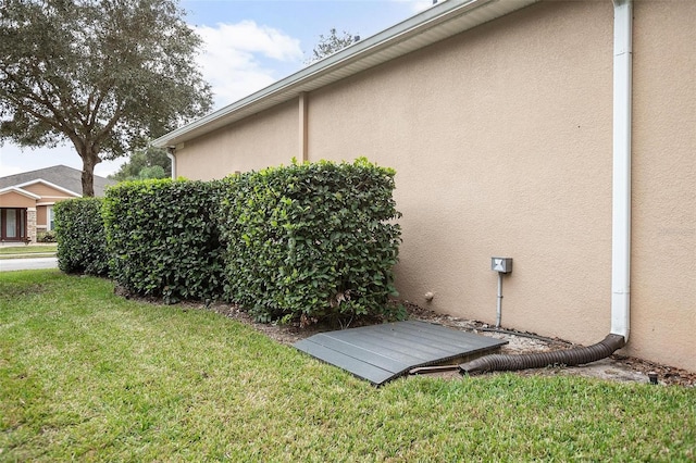 view of side of home featuring a lawn