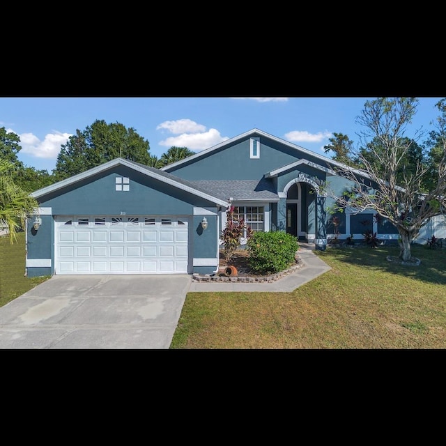 view of front of property featuring a front lawn and a garage