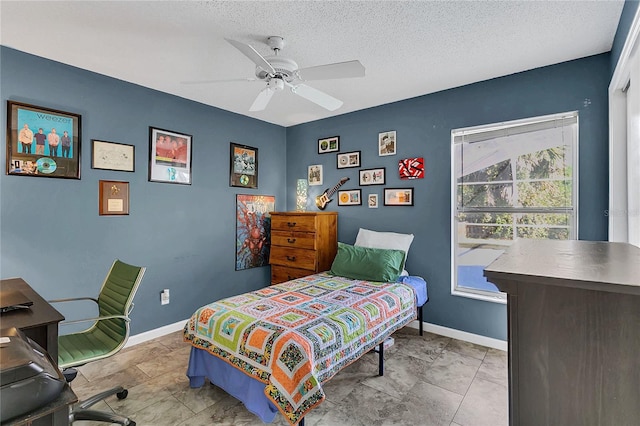 tiled bedroom with ceiling fan and a textured ceiling