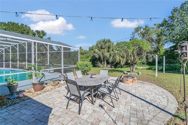 view of patio featuring glass enclosure