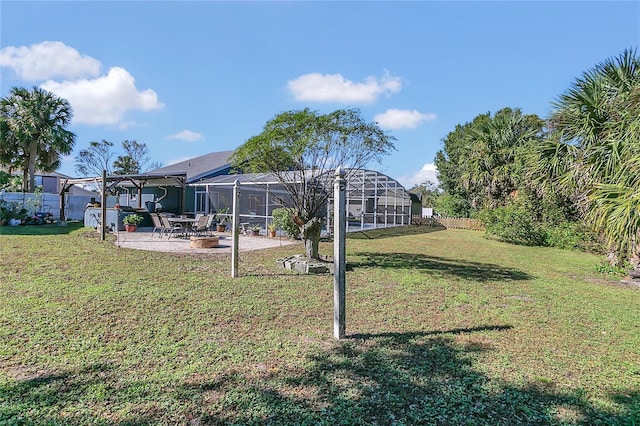 view of yard with glass enclosure and a patio area