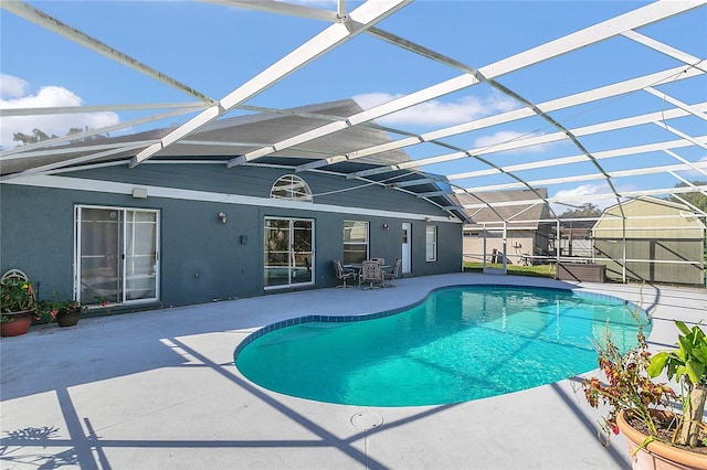 view of pool with a lanai and a patio