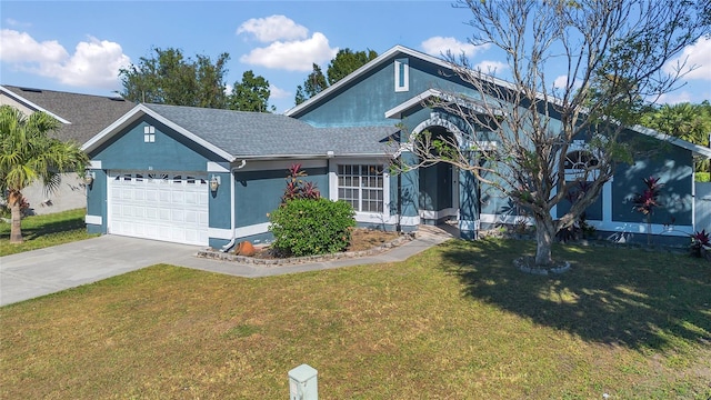 view of front of home with a front lawn and a garage