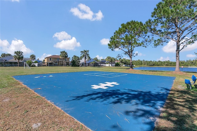 view of basketball court featuring a yard