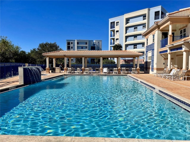 view of pool featuring pool water feature and a patio area