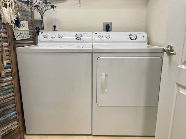 laundry area featuring light tile patterned flooring and separate washer and dryer