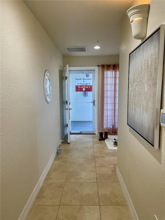 hallway with light tile patterned flooring