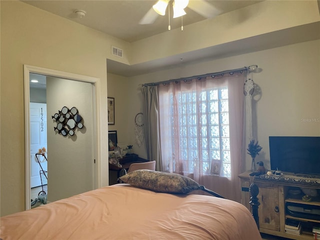 bedroom with ceiling fan and a closet