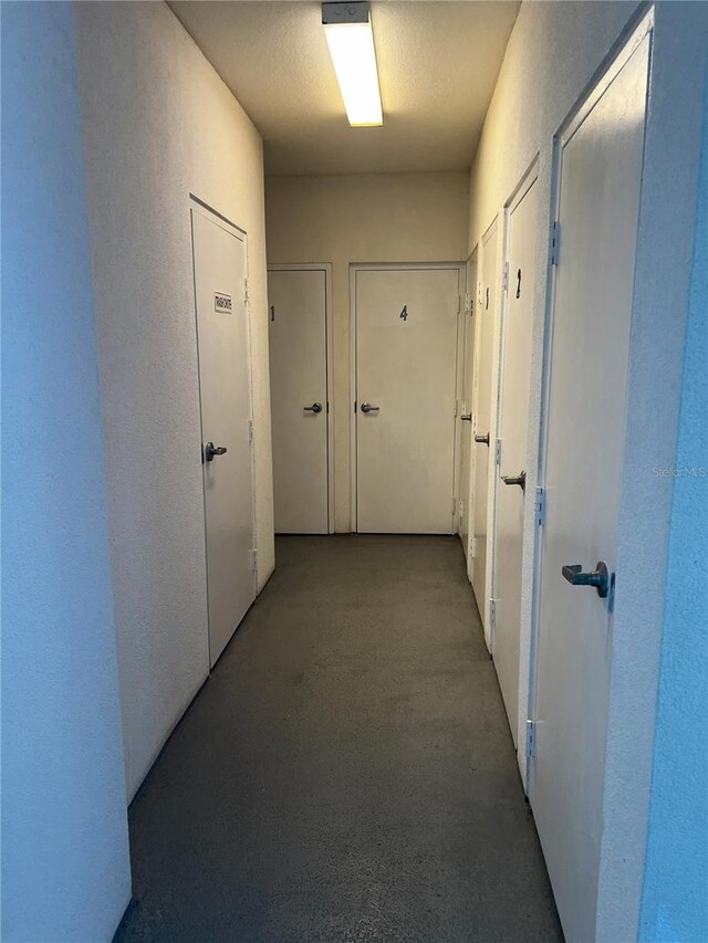 hallway with a textured ceiling