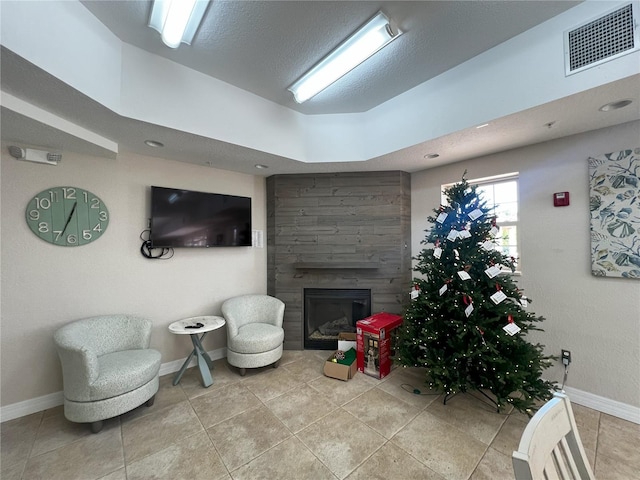 living room featuring a tiled fireplace