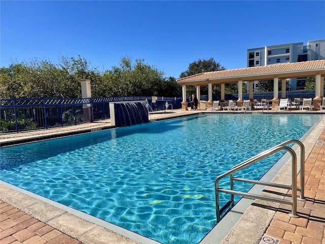 view of pool featuring pool water feature and a patio area