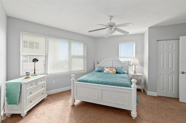 bedroom featuring ceiling fan, light colored carpet, and a closet