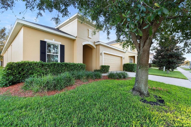 view of front of property with a front yard and a garage