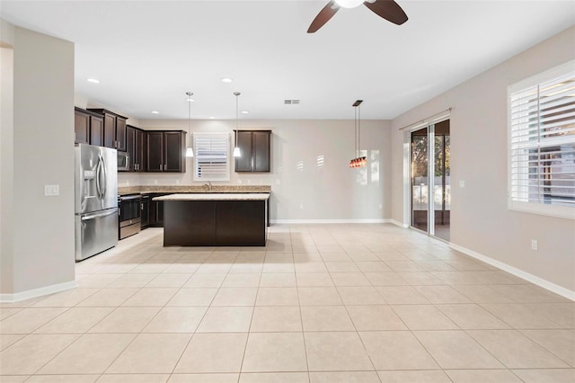 kitchen featuring stainless steel appliances, ceiling fan, light tile patterned floors, a kitchen island, and hanging light fixtures