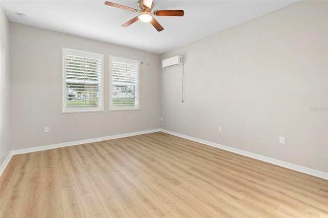 unfurnished room featuring ceiling fan, an AC wall unit, and light hardwood / wood-style flooring