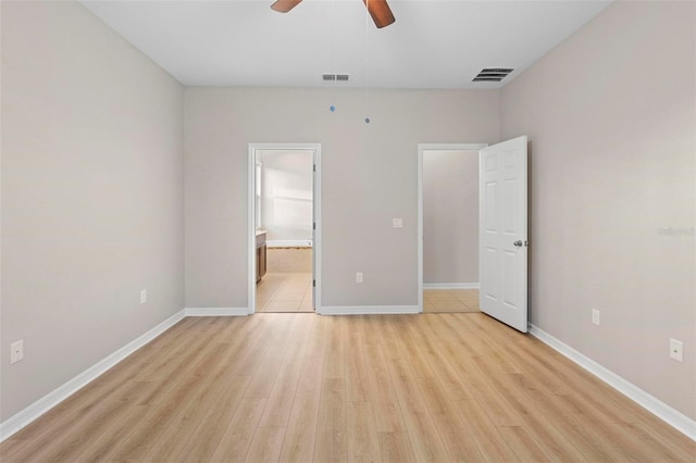 unfurnished bedroom with ceiling fan, light hardwood / wood-style floors, and connected bathroom