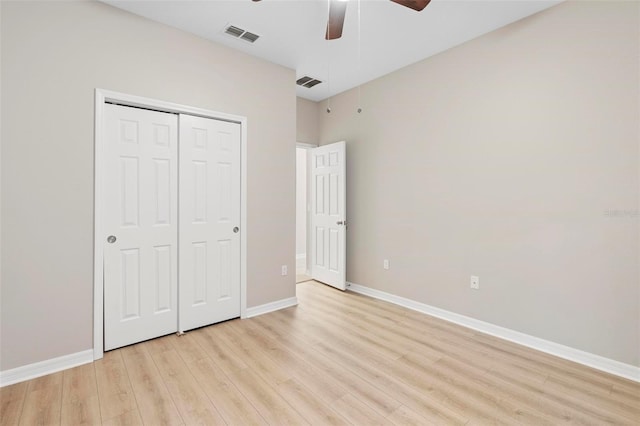 unfurnished bedroom featuring ceiling fan, a closet, and light hardwood / wood-style flooring