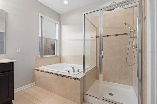 bathroom featuring tile patterned floors, vanity, and separate shower and tub