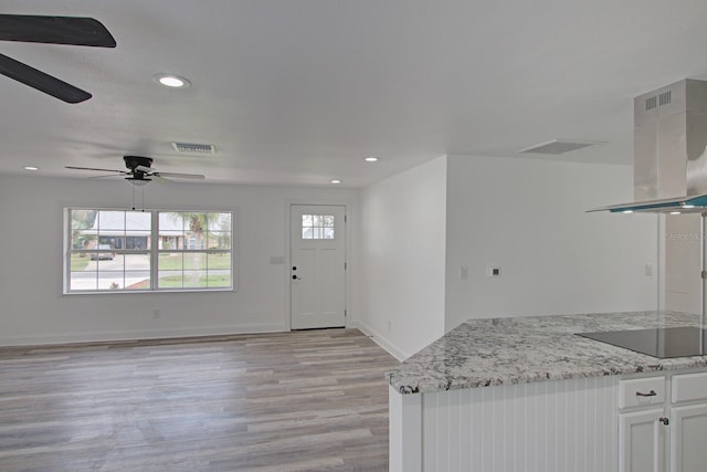 foyer featuring ceiling fan and light wood-type flooring