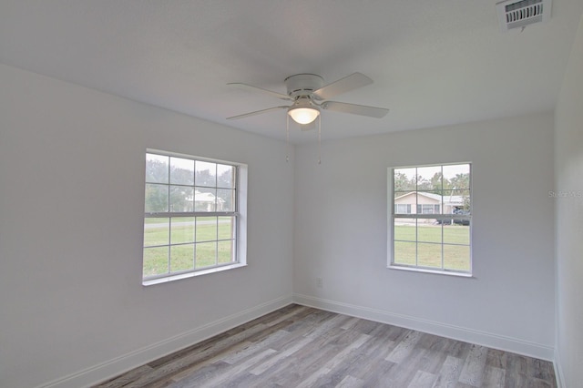 spare room with ceiling fan and light hardwood / wood-style floors