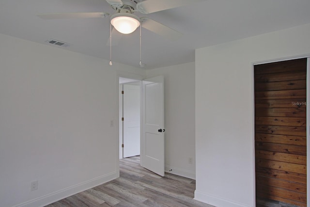 spare room with light hardwood / wood-style flooring and ceiling fan