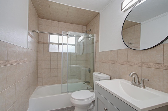 full bathroom with toilet, combined bath / shower with glass door, tile walls, and vanity