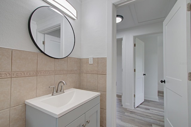 bathroom featuring hardwood / wood-style flooring, vanity, and tile walls