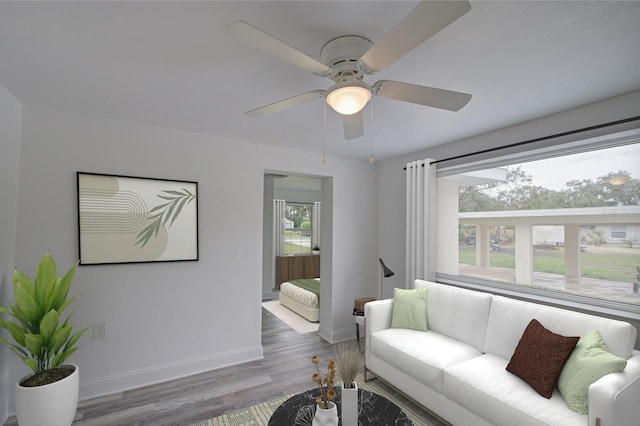 living room with ceiling fan, dark hardwood / wood-style flooring, and a healthy amount of sunlight