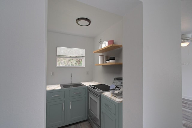 kitchen featuring hardwood / wood-style flooring, range with electric stovetop, and sink